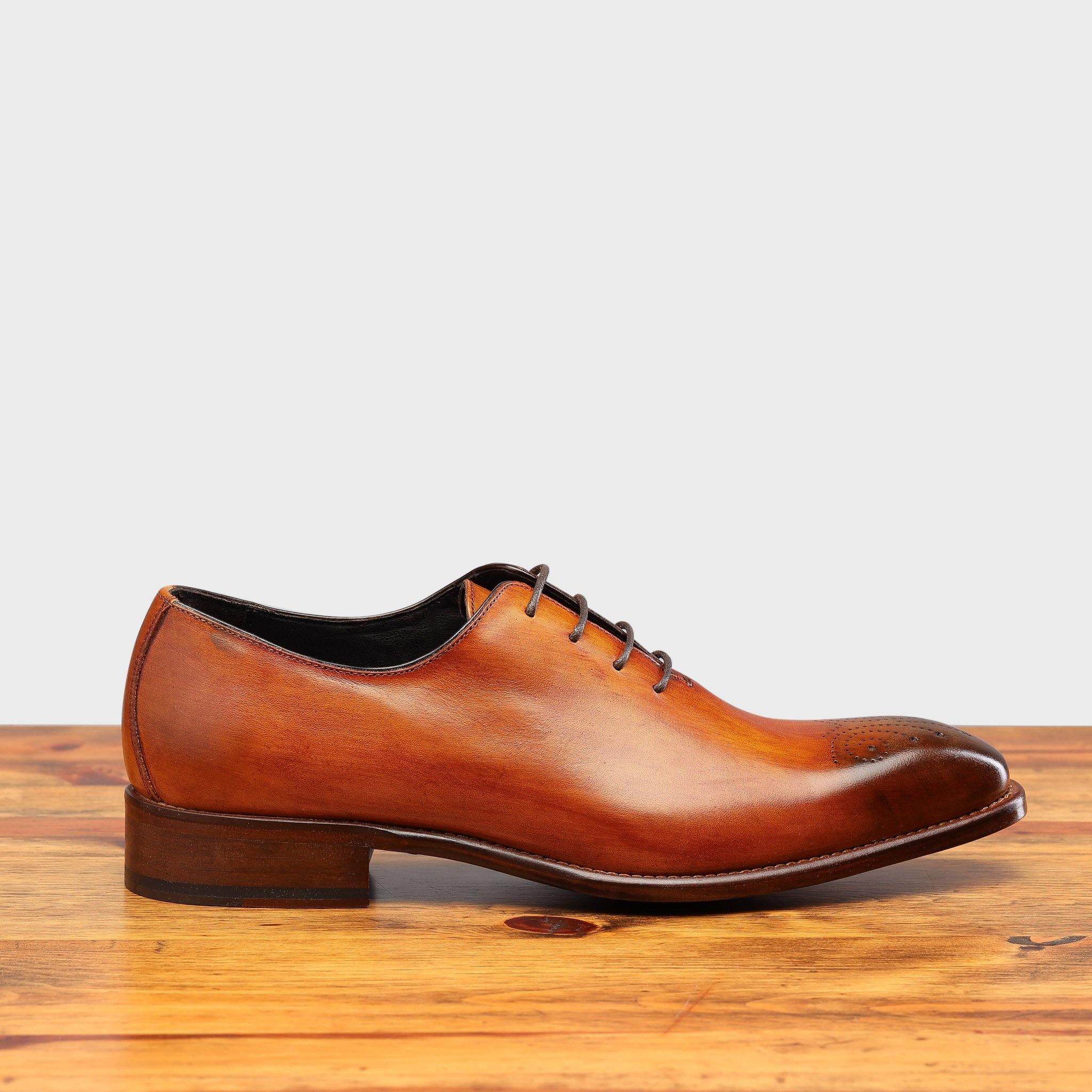 Side profile of 4633 Calzoleria Toscana Dark Caramel Wholecut Balmoral on top of a wooden table